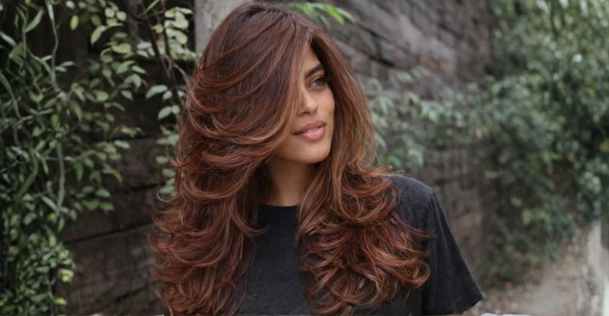 Butterfly hairstyle with blonde balayage and soft, voluminous waves.