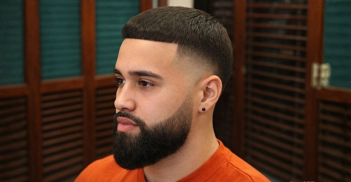 High taper fade with sculpted beard and sharp hair-to-beard transition.