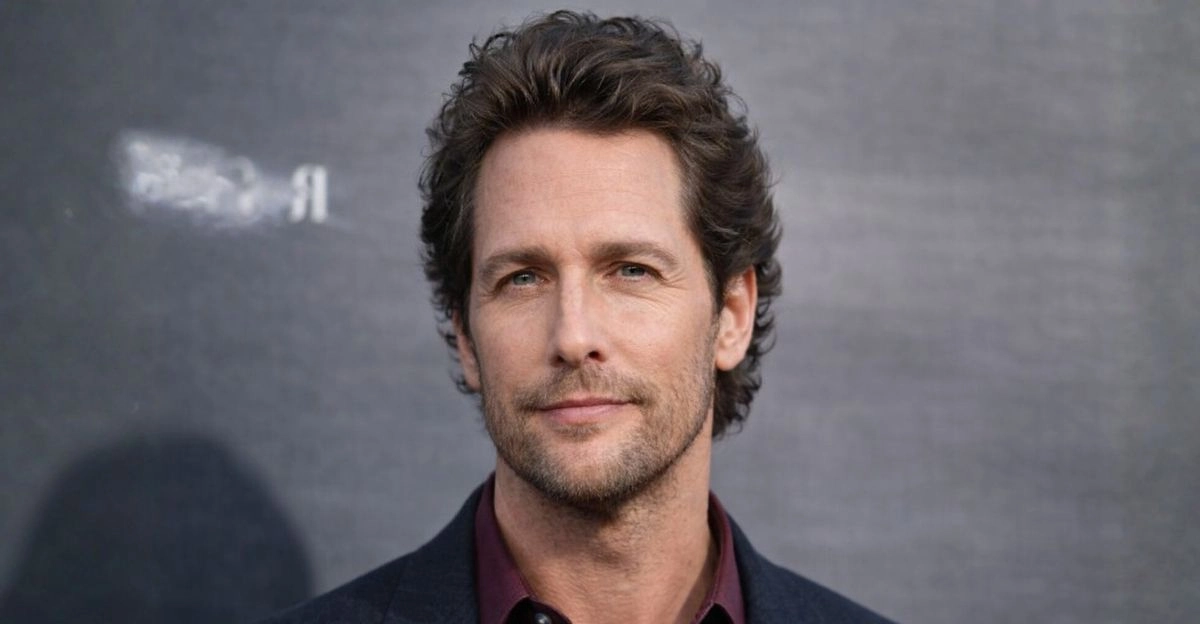 Medium layered haircut with soft waves and volume that balances a larger forehead shape.